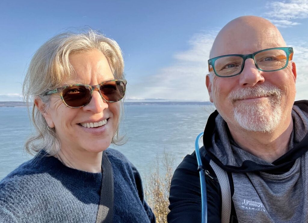 Heather and John standing in front the ocean